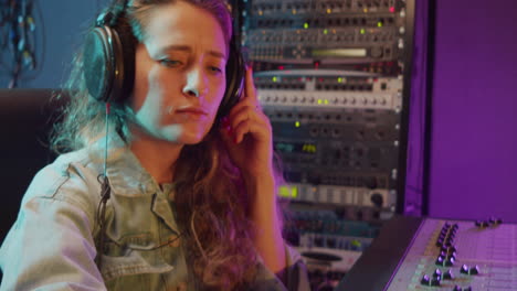 Woman-Working-with-Mixing-Desk-in-Recording-Studio